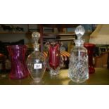 3 cranberry glass vases and 2 decanters.