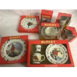 A collection of Wedgwood Rupert nurseyware including clock, plates, money box etc.