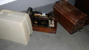 A Singer sewing machine and one other.
