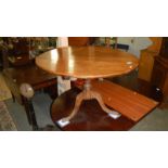 An oak tripod table.