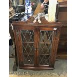 An oak lead glazed corner cabinet.