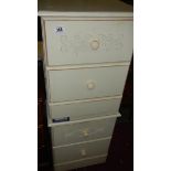 A pair of white bedside chests.