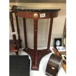 A mahogany occasional table with marble effect top.