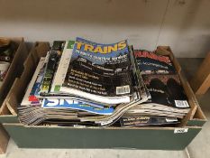 A box of Train magazines.