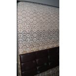 A double divan bed with headboard.