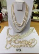 5 faux pearl necklaces including one opera length.