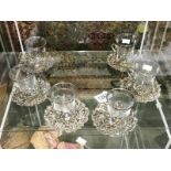 A set of 6 glass and metal cups and saucers.