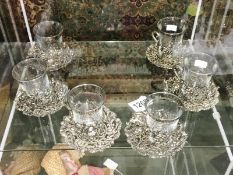 A set of 6 glass and metal cups and saucers.