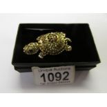A jewelled tortoise brooch with articulated head.