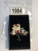 An enameled Santa Clause with animals brooch.