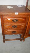 An oak three drawer chest.