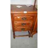 An oak three drawer chest.