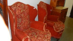 A pair of wing arm chairs.