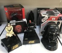 A collection of electronic Star Wars items including talking Banks and Darth Vader radio and CD