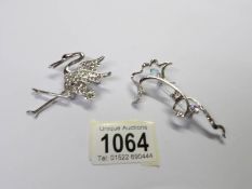 A jewelled stork brooch and one other.