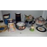 A shelf of assorted jugs, bowls, teapot, teapot stands etc.