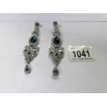 A pair of drop earrings set white stones.