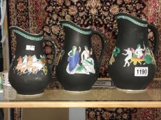 A set of 3 graduated jugs with Grecian scenes.