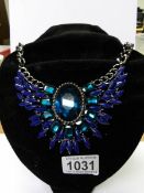 A heavy blue stone necklace.