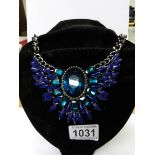 A heavy blue stone necklace.