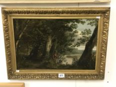 A 19th century British school oil on canvas of a figure seated by a lane in woods with river.