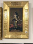 A 19th century oil on canvas 'Arabian semi nude female with sword' in gilt wood lattice frame.