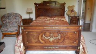 A wood framed bed with headboard