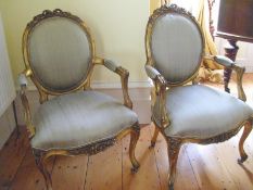 A pair of gilt framed chairs