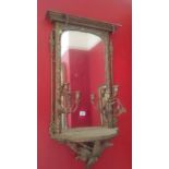 A pair of mirrors in gilt frames with candle sconces