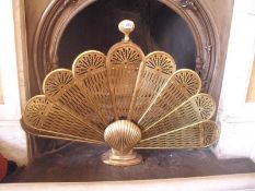 A peacock feathers style brass fire screen