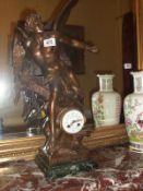 An ornate mantel clock surmounted winged figure,