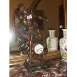 An ornate mantel clock surmounted winged figure,