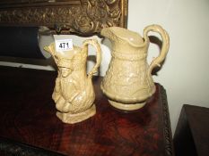 A stoneware jug decorated with figures and one other,