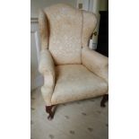 An Edwardian wing armchair