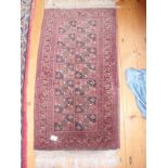 A Persian fringed rug 54cm x 43cm