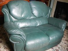 A two seater green leather settee