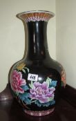 A large pottery vase hand painted with flowers.