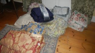 A large quantity of bedding some with matching curtains.