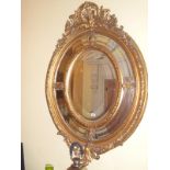 A fine oval gilt partitioned mirror