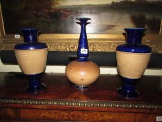 A pair of Doulton Lambeth vases and one other.