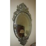A large ornate oval mirror