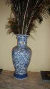 An oriental blue and white vase (with peacock feathers)