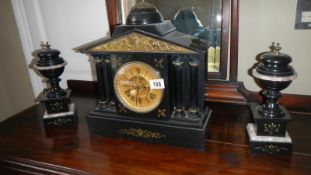 A black slate clock garniture