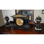 A black slate clock garniture