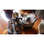 A 3 piece silver plate tea set and an egg cup stand.