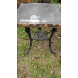 An old cast aluminium triple legged table - top a/f