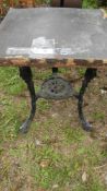 An old cast aluminium triple legged table - top a/f