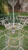 An ornate wire work plant display unit