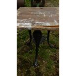 An old cast aluminium triple legged table - top a/f