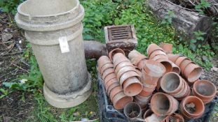 An old drain and chimney pot and a quantity of terracotta plant pots etc.